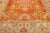 Beautiful Antique Turkish hand-knotted wool rug with an orange color field. This rug has a designed frame with tan, beige,...