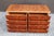 Rich burl wood veneer with dramatic swirling grain throughout the drawer fronts, top, and sides. Brass and black details....