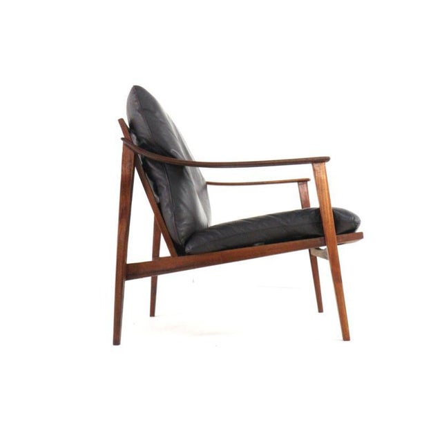 The "Sugenheim" might just be the perfect armchair for you! with its beautiful dark wood frame and original black leather...