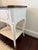 Sweet side table with a wooden top over a distressed white painted bottom. Table features a single drawer with brass pull...