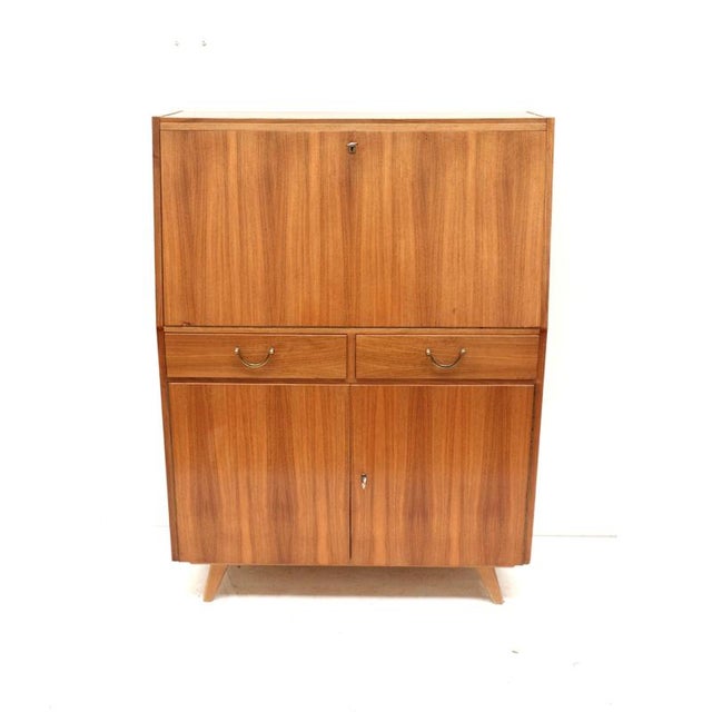 Vintage secretary desk with drawers, flap, and doors made in the 1960s. Compact vintage secretary desk from the 1960s with...