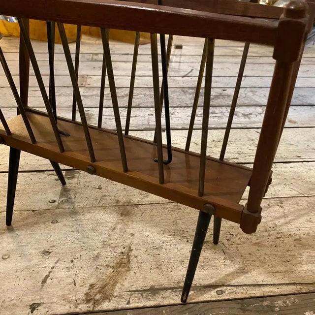 This Italian magazine stand represents the era's fascination with sleek, functional design, and the harmonious blend of...