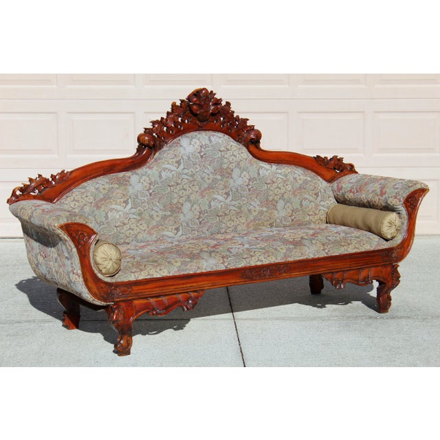 Bring timeless elegance to your home with this early 20th-century Victorian Rococo Revival rosewood sofa, adorned with...