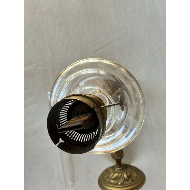 Vintage solid brass oil lamp with glass chimney. This authentic lamp has a lacquered antique brass finish.