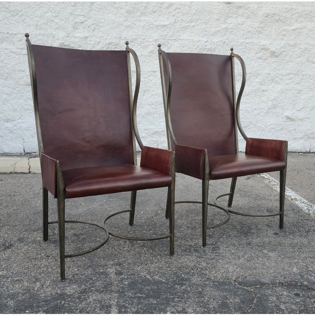 This is a beautiful pair of sculptural metal and leather wingback armchairs by Global Views. They feature a tall, elegant...
