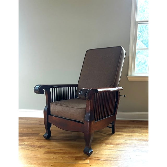 Beautiful early 20th century solid wood Morris style reclining chair. The chair features a slatted backrest with a solid...