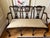 An unusual Chippendale style, triple chair settee of hand carved mahogany having a serpentine shaped top rail, 3...