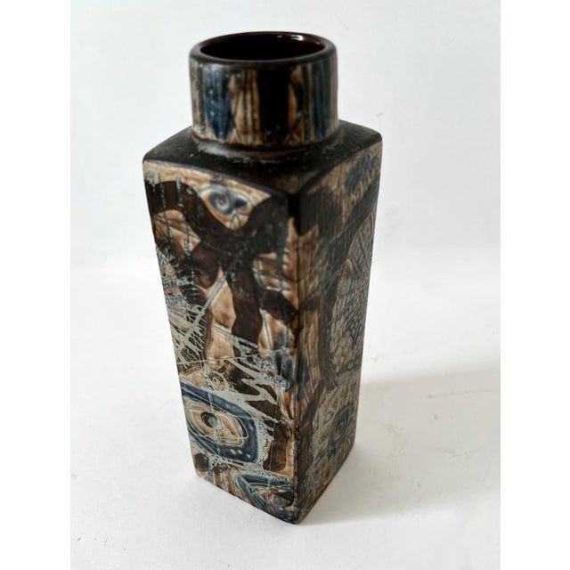 a wonderful square cylinder vase with a round top - the piece has been artistically desgined with a starburst and other...