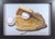 This artwork presents a meticulously rendered vintage baseball glove cradling two baseballs, showcasing the intricate...