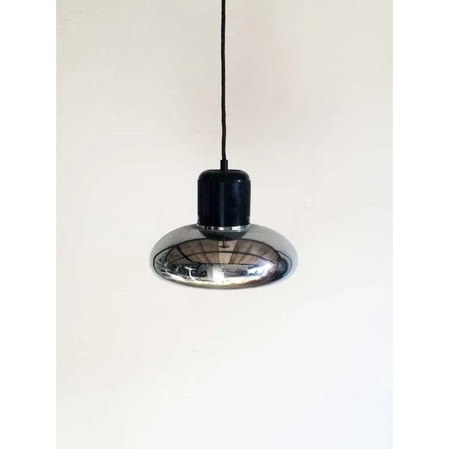 Designed by Gae Aulenti and manufactured by Stilnovo, consisting of a cast body of black makrolon and of a metal chromed...