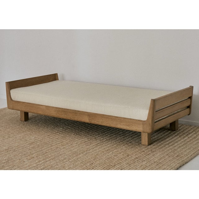 Vintage French daybed by Guillerme & Chambron. Featuring a solid light oak frame with rounded edges, and a mattress that...