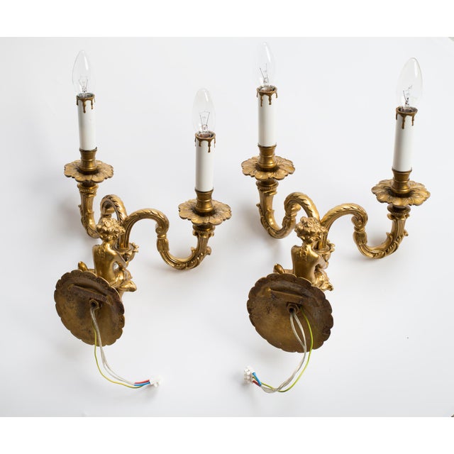 Pair of French heavy (the weight of the pair is over 13 lbs) solid bronze electrical wall sconces with two relieve...