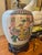 This Chinoiserie lamp is made from a ginger jar with a lid. The porcelain lamp is decorated with traditional Asian figures...