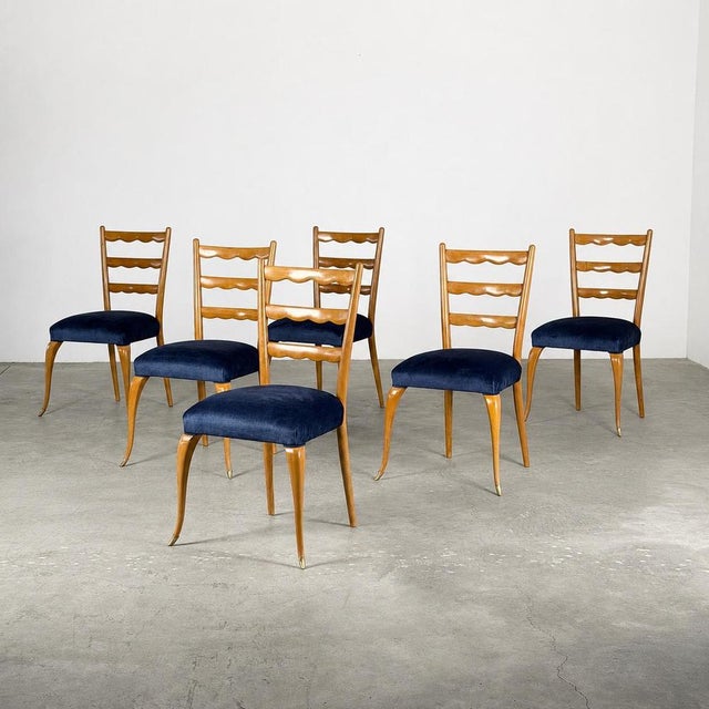 Designed by Paolo Buffa and produced in Italy during the 1950s, this exquisite set of six dining chairs represents the...