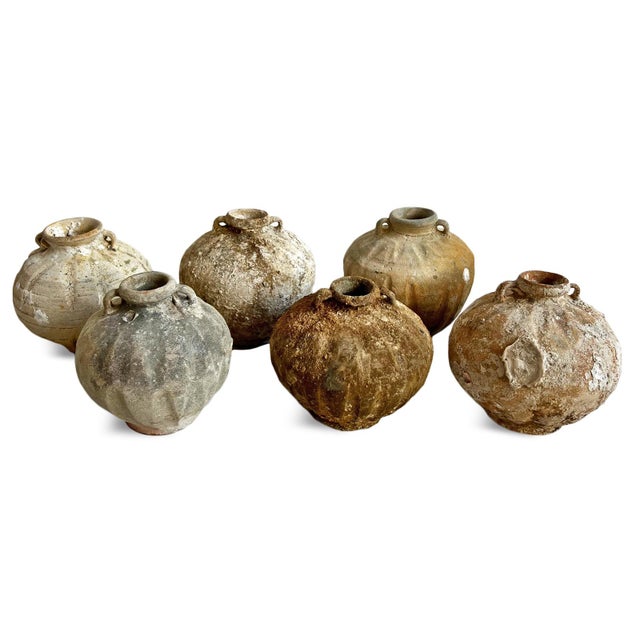 Antique small earthware pots from the coast of Indonesia. Each is unique with signs of age and barnacles and shells, and...