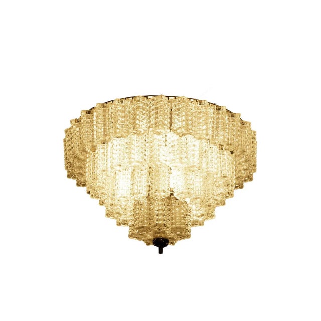 Italian chandelier in parallelepiped glass composed by four ranks that get smaller with glass rectangular tassels with...