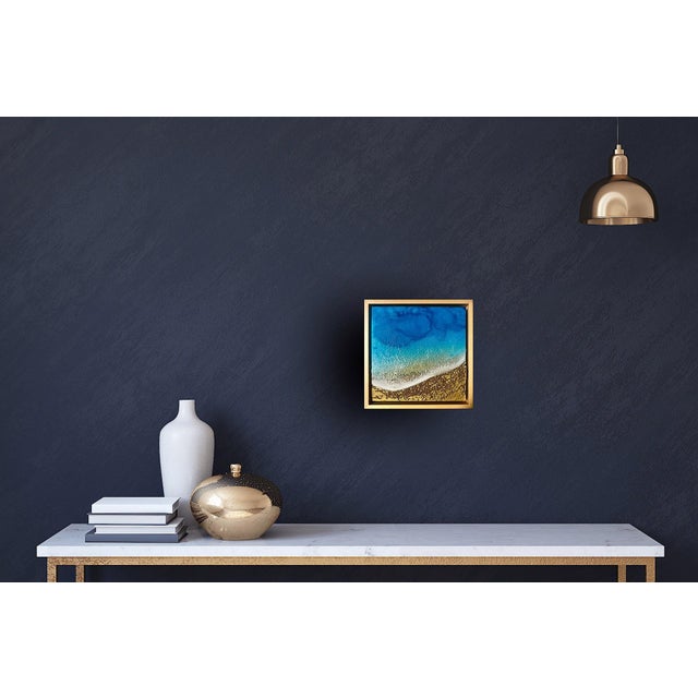 This mixed media artwork captures the serene beauty of a tranquil beach scene, with vibrant turquoise waters meeting a...