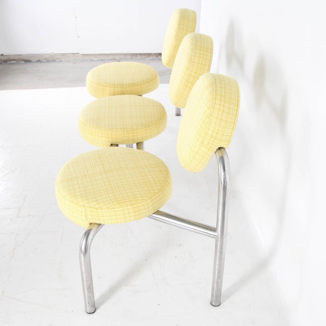Rare bench with its chromed tubular steel frame and round seats and backs upholstered in a lovely yellow fabric in perfect...