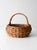 A vintage coil basket with a softly rounded form and an arched handle, finished in a warm natural tone. Easy and...