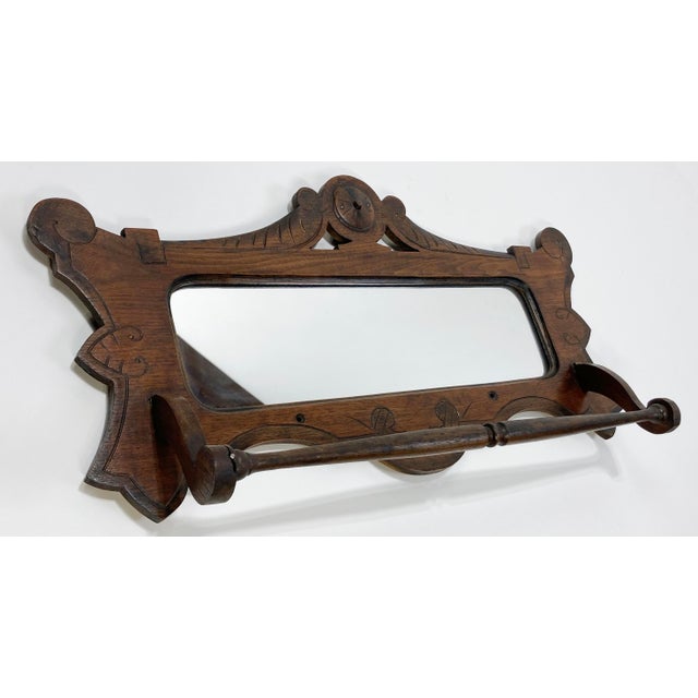 Antique Victorian natural wood wall mount shaving mirror with drop down towel rack. Wonderful frame and intricate carved...
