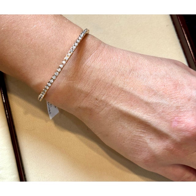 Iconic and stylish, this flexible diamond bangle bracelet is designed to make a statement. Crafted from 18K White, Yellow,...