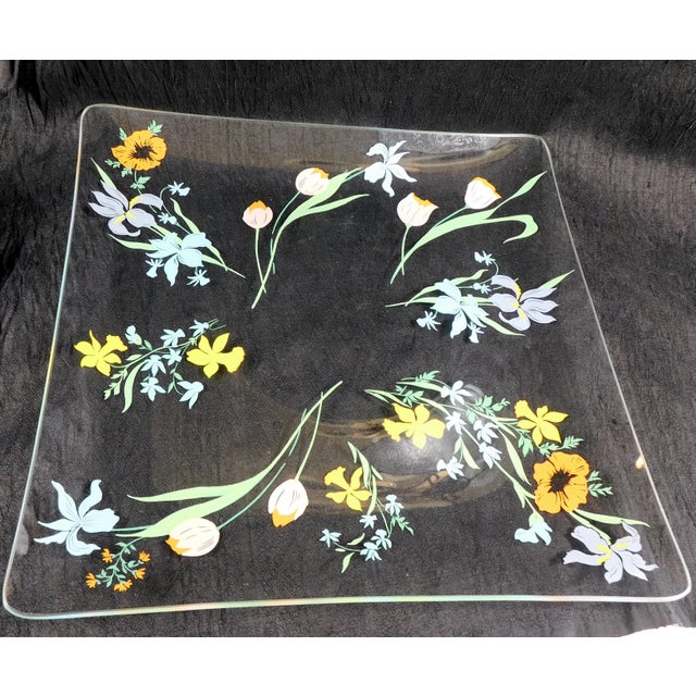 This is a large square, clear glass serving tray by Heinrich & Co. in the Primavera pattern from 1977. The tray is clear...