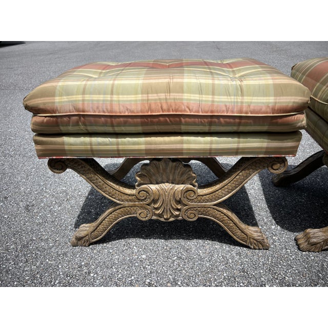 Upholstered seat frame plaid cover and the scrolling X-frame support with imbricated channels centered with a stylized...