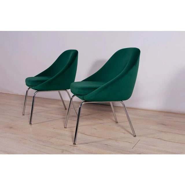 A pair of armchairs made in Great Britain in the 1960s. The armchairs have undergone upholstery renovation. Upholstery...