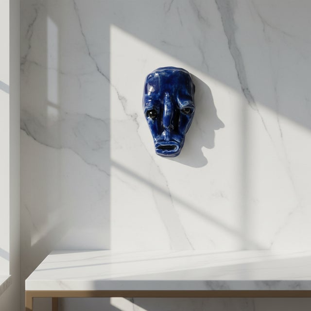 This expressive vintage wall mask is crafted in glazed ceramic and finished in a rich blue tone, giving it a striking and...