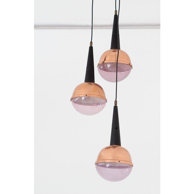 Modern pendant lamp manufactured in Italy during the 1960s. The ceiling light feature black enameled iron with bronze and...