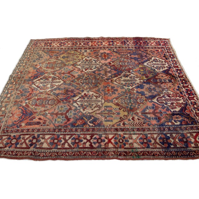 Beautiful Bakhtiari Handmade Wool rug with a blue field in an all-over multi-medallion design. This rug measures: 5'8'' X...