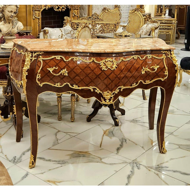 Elevate your interior with this magnificent French Louis XV Commode, a timeless statement piece crafted from solid wood...