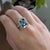 A london blue topaz glows in a deep, steely blue at the centre of this solid 14K white & yellow gold ring, encircled by...