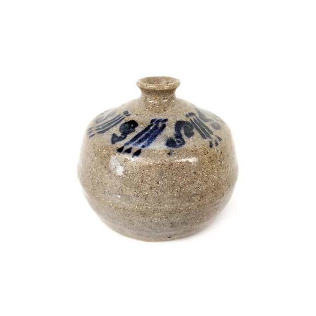 This M Hanes original art pottery vase is a hand-thrown piece with a unique brown and dark blue color scheme. Standing at...
