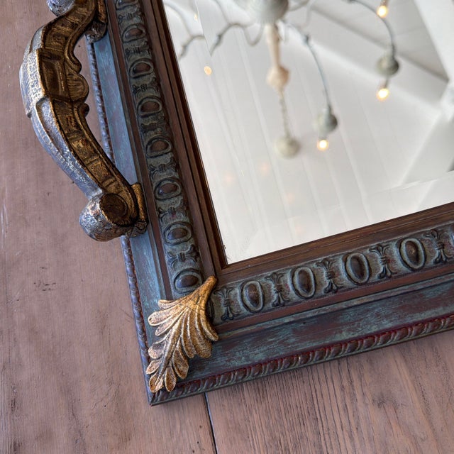 This large, dramatic gold-handled mirrored tray features a verdigris patina decorated with a scrollwork design and four...
