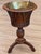 An early 19th C. English flared mahogany bucket made of slender curved slats beneath a molded rim, holding a removable...