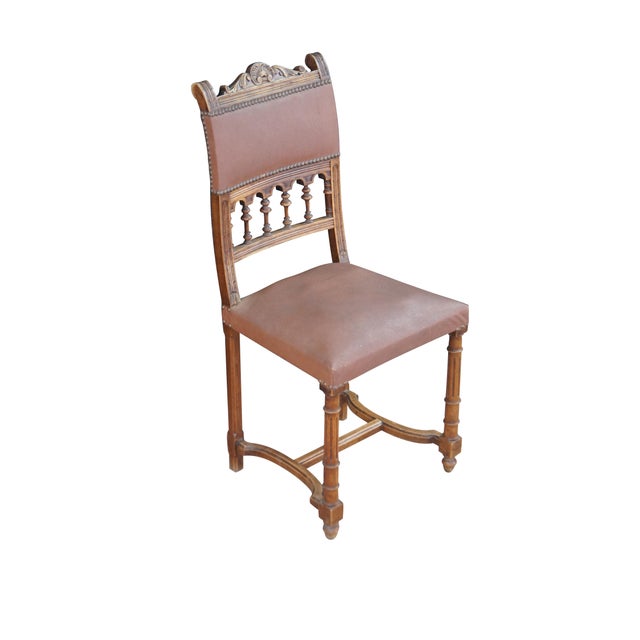 An antique French Henry II style / Gothic Revival dining side chair. Features an oak frame with nailhead accents, a...