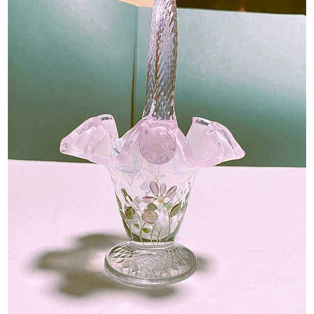 A collectible, hand-painted art glass basket by Fenton, featuring signature by artist S. Massey. Pink opalescent glass...