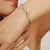 This Contemporary Twin Emerald & Diamond Halo Open Cuff Bangle is crafted in polished 925 sterling silver, featuring two...