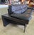 This low-profile three-seater is highly distinctive due to its thick, comfortable black leather cushions, wide track...