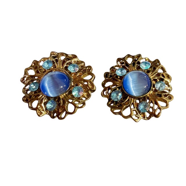 Vintage Clip-On Earrings. these earrings feature round blue stones and gold accents, measuring 1 inches in diameter and...