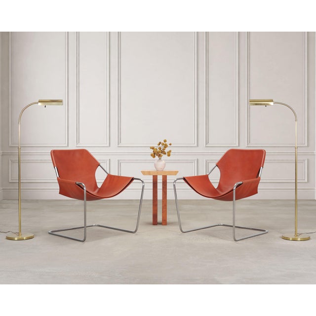 A chic pair of genuine labeled cantilevered 'Paulistano' lounge chairs in optional leather and chromed steel designed by...