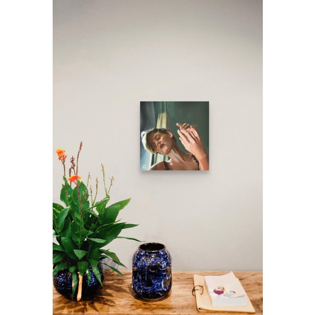 Mirrored Touch captures a moment of introspection, with a figure gently holding their hands together in a soft,...