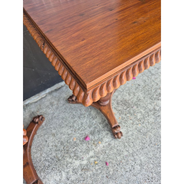 Handsome pair of 19th Century Anglo Indian tables crafted in mahogany having carved edges on top set on turned pedestals...