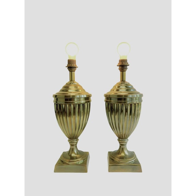A set of urn-shaped table lamps with vertical fluting. These elegant lamps are inspired by the Empire style. They are...