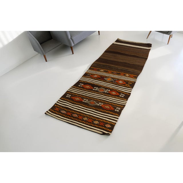 This is a vintage Turkish Oushak rug from the Mid 20th Century. The piece was hand-knotted.