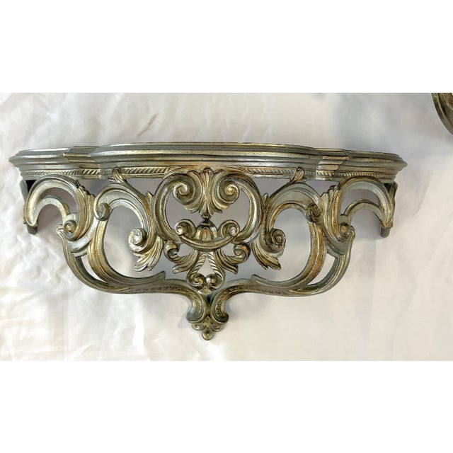 Fancy pair of Hollywood Regency style wall console shelves from the late 20th century. They are made of cast plastic...