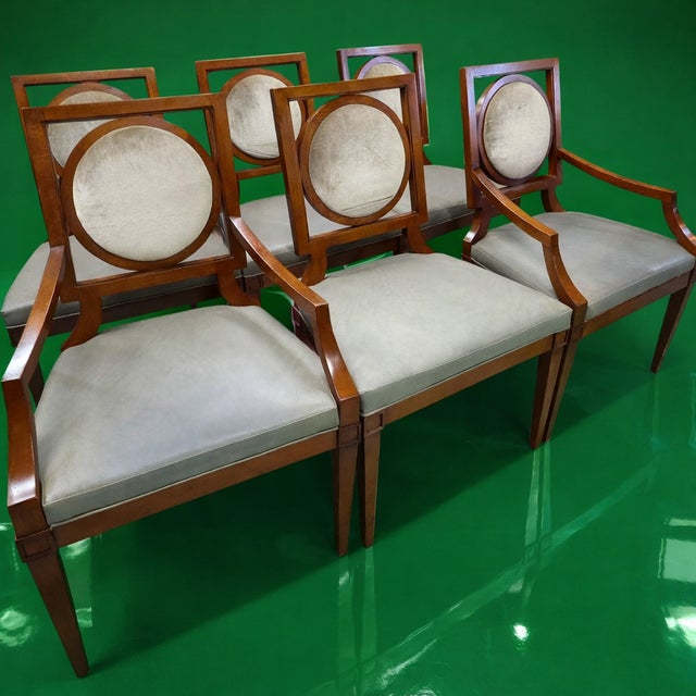 This Set of Six Baker Furniture dining chairs in a modern neoclassical Regency style, includes two armchairs and four side...
