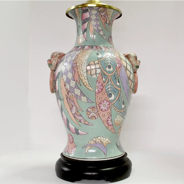 Table lamp asian inspired decoration including images of foo dogs, a pattern of stylized feathers, flowers, and geometric...