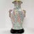 Table lamp asian inspired decoration including images of foo dogs, a pattern of stylized feathers, flowers, and geometric...